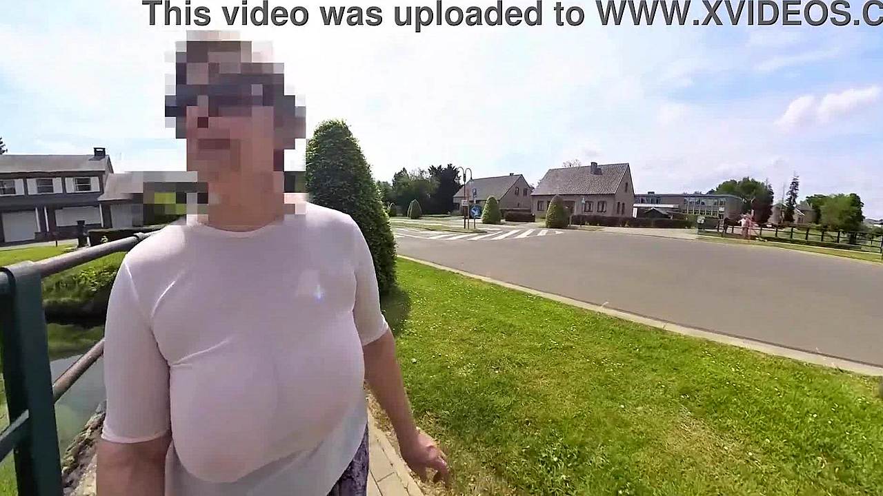 busty milf braless in transparent top strolls street