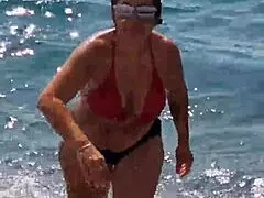 Feeling wild watching a slutty wife suck on the beach.