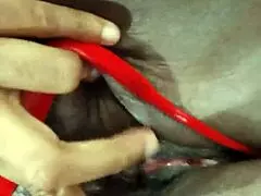 An ebony woman is enjoying some personal time with toys in lingerie