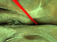 An ebony woman is enjoying some personal time with toys in lingerie