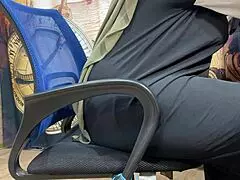 Arab woman in hijab rubs herself through panties during work break.