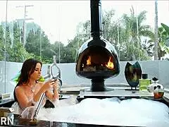 a stunning brunette milf with big tits plays with herself in the bathroom.