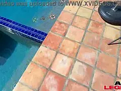 Drop-dead gorgeous MILF massages big dick by the pool