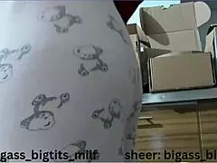 mature woman in pajamas masturbates with vibrator, showing wet cameltoe and big natural tits