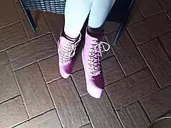 sitting on a chair in pantyhose and high heeled boots, looking sexy as a latina milf