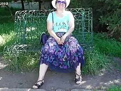 Hairy mature flashes assets in sheer outdoor dress.