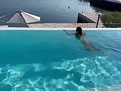 Monika Fox swims naked in the pool, her big tits exposed