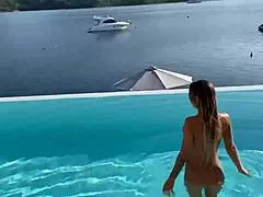 Monika Fox swims naked in the pool, her big tits exposed