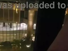 Petite babe masturbates openly by hotel window for all to see.