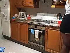 Latina in miniskirt surprised in the kitchen