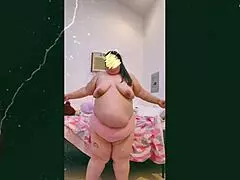 mature old cougar performs topless dance in front of webcam, showcasing natural saggy tits