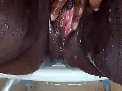 Black milf shaves her wet pussy with toys and tattoos on display