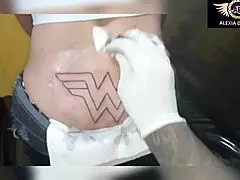 Tattoo artist mimics Anitta while inking model Alexia Duucan TS. Best moments of the tgata getting a butt tattoo.