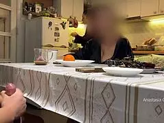 Husband jerking under table in front of step mom in kitchen