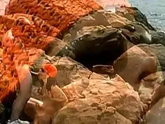 A mature man fucks an exotic babe on seaside stones