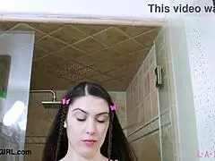 Sophisticated dark-haired woman takes a relaxing shower after a long day at home