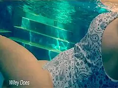 I watch my wife swim in the hotel pool.