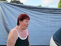 filthy kiwi mature milf squats to piss on the campground ground with campers nearby, staying submissive