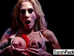 Sarah's tattooed body trembles as she stuffs her pussy with a red toy, feeling pure ecstasy.