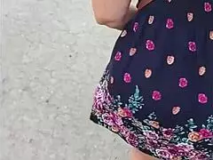 Following this mature woman in her skirt and thong on the street