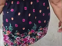 Following this mature woman in her skirt and thong on the street