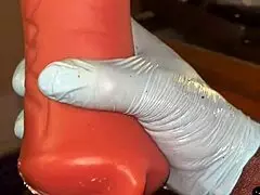 Stocking-clad person deep throats a toy intensely.