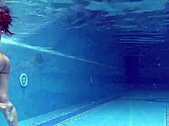 In the pool, a Hungarian woman plays naked sazan cheharda, swimming and teasing underwater with playful moves.