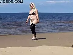 big leather ass strolls along the sandy beach in nature