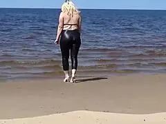 big leather ass strolls along the sandy beach in nature
