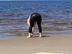big leather ass strolls along the sandy beach in nature