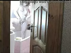 Naked blonde in bathroom, roommate watches and cums on her wet pussy?