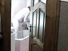 Naked blonde in bathroom, roommate watches and cums on her wet pussy?