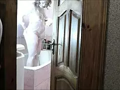 Naked blonde in bathroom, roommate watches and cums on her wet pussy?