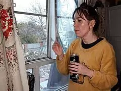 The stepsister lights up a cigarette in a quiet moment