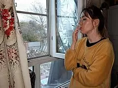 The stepsister lights up a cigarette in a quiet moment