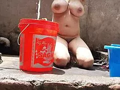 village indian bhabhi bathes outdoors flashing huge tits and shaved pussy for hungry eyes