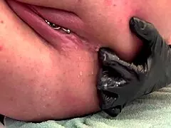close up on shaved pussy lips and pierced clit as she pisses outdoors