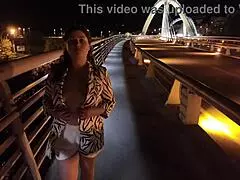 wow, check out this luscious milf flashing her big natural tits on the bridge without bra or panties