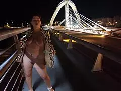 wow, check out this luscious milf flashing her big natural tits on the bridge without bra or panties