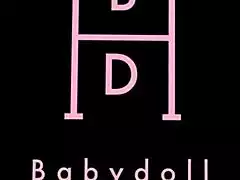 Babydoll fingers her shaved pussy lips in horny solo play