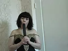 brunette milf in green pantyhose rams big black dildo deep into her soaking hairy pussy.