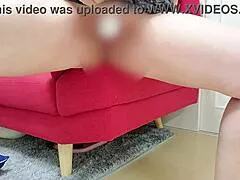 Hey, check out this lewd Japanese wife masturbating wildly on the sofa at home.