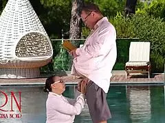regina noir sneaks a teasing blowjob by the public swimming pool at the nudist hotel sucking dick like a pro while her neighbors watch her naked curves