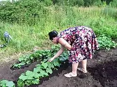 mature housewife masturbates with a cucumber in the garden outdoors