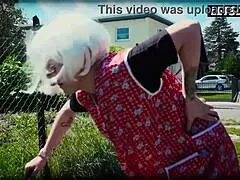 German granny in cosplay stands outdoors in costume