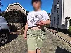 Milf shows big saggy tits outdoors in street