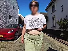 Milf shows big saggy tits outdoors in street